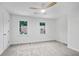 Bright, carpeted bedroom featuring a modern ceiling fan and two large windows at 3144 Corner Oak Dr, Norcross, GA 30071