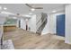 Bright, open-concept living room with hardwood floors and staircase at 3144 Corner Oak Dr, Norcross, GA 30071