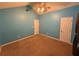 Bedroom with blue walls, a ceiling fan, and a double door closet at 608 Fairhaven Blvd, Stockbridge, GA 30281