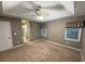 Bedroom with neutral walls, plush carpet, tray ceiling, and natural light from two windows at 608 Fairhaven Blvd, Stockbridge, GA 30281