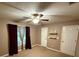 Spacious bedroom with neutral carpet, a ceiling fan, and a double door closet at 608 Fairhaven Blvd, Stockbridge, GA 30281