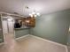 Dining room featuring hanging pendant light fixture and access to the kitchen and living area at 608 Fairhaven Blvd, Stockbridge, GA 30281