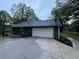 Attached garage with a wide driveway, exterior paint matching the shed in the rear yard at 608 Fairhaven Blvd, Stockbridge, GA 30281