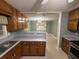 Kitchen featuring a stainless steel oven, wood cabinets, and view into dining room at 608 Fairhaven Blvd, Stockbridge, GA 30281