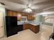 Kitchen featuring wood cabinetry, gray countertops, and modern appliances with a breakfast bar at 608 Fairhaven Blvd, Stockbridge, GA 30281