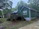 Exterior rear view with deck, steps, and view of surrounding homes at 608 Fairhaven Blvd, Stockbridge, GA 30281