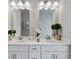 This bright bathroom features double sinks, white cabinets, and stylish light fixtures at 14 Jacobs Farm Ln # 7, Lawrenceville, GA 30045