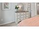 This bedroom features a distressed dresser with a mirror and neutral decor at 14 Jacobs Farm Ln # 7, Lawrenceville, GA 30045