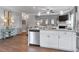 Bright open kitchen features stainless appliances, white cabinetry, and an island with granite countertops at 14 Jacobs Farm Ln # 7, Lawrenceville, GA 30045