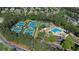 Aerial view of community amenities featuring tennis courts and a large pool with ample seating and a slide at 1409 Spyglass Hill Dr, Johns Creek, GA 30097