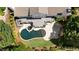 Aerial view of a home featuring a backyard pool, hot tub, deck, and stone patio at 1409 Spyglass Hill Dr, Johns Creek, GA 30097