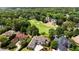 Aerial view showcasing the property's proximity to the golf course and surrounding mature trees at 1409 Spyglass Hill Dr, Johns Creek, GA 30097