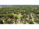 Aerial view showcasing a neighborhood and golf course surrounded by lush trees at 1409 Spyglass Hill Dr, Johns Creek, GA 30097