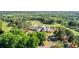 Aerial view of a clubhouse in a lush green surrounding with a golf course and parking area at 1409 Spyglass Hill Dr, Johns Creek, GA 30097