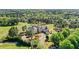 Aerial view showcasing a clubhouse and lush green landscaping on a golf course at 1409 Spyglass Hill Dr, Johns Creek, GA 30097