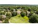 Aerial view of a home surrounded by mature trees and landscaping in a neighborhood setting at 1409 Spyglass Hill Dr, Johns Creek, GA 30097