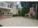 Backyard with an outdoor brick fireplace and concrete patio at 1409 Spyglass Hill Dr, Johns Creek, GA 30097