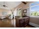 Living room wet bar features granite counters and cabinetry, next to large windows at 1409 Spyglass Hill Dr, Johns Creek, GA 30097