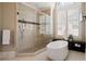 Beautiful bathroom featuring a freestanding tub, a glass shower, and a large window at 1409 Spyglass Hill Dr, Johns Creek, GA 30097