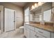 Well-lit bathroom with a granite countertop, white cabinets, and a shower with glass doors at 1409 Spyglass Hill Dr, Johns Creek, GA 30097