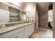 Neutral bathroom features granite double vanity and a sliding glass shower at 1409 Spyglass Hill Dr, Johns Creek, GA 30097