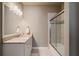 Bright bathroom features a granite vanity and sliding glass door shower at 1409 Spyglass Hill Dr, Johns Creek, GA 30097