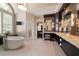 Modern bathroom with a soaking tub, vanity with double sinks, and a decorative mirror at 1409 Spyglass Hill Dr, Johns Creek, GA 30097