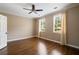 Inviting bedroom with hardwood floors, crown molding, and two large windows at 1409 Spyglass Hill Dr, Johns Creek, GA 30097