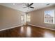 Bright bedroom with hardwood floors, neutral walls, and recessed lighting at 1409 Spyglass Hill Dr, Johns Creek, GA 30097