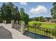 Gorgeous outdoor living space with views of golf course and a swimming pool below at 1409 Spyglass Hill Dr, Johns Creek, GA 30097