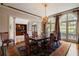 Elegant dining room with chandelier, rug, and large windows offering natural light and scenic views at 1409 Spyglass Hill Dr, Johns Creek, GA 30097
