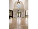 Grand foyer with high ceilings, stone flooring, and decorative front door at 1409 Spyglass Hill Dr, Johns Creek, GA 30097