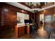 Stately home office with wooden paneling, desk, and a spiral staircase visible beyond at 1409 Spyglass Hill Dr, Johns Creek, GA 30097