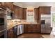 Gourmet kitchen featuring stainless steel appliances, granite counters, and wood cabinets at 1409 Spyglass Hill Dr, Johns Creek, GA 30097
