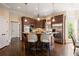 Modern kitchen with center island, pendant lighting, stainless steel appliances and wood floors at 1409 Spyglass Hill Dr, Johns Creek, GA 30097