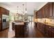 Bright kitchen showcases large island with seating, stainless appliances, and dark cabinetry at 1409 Spyglass Hill Dr, Johns Creek, GA 30097