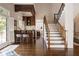 Open floor plan features wet bar, staircase with wood and iron railing at 1409 Spyglass Hill Dr, Johns Creek, GA 30097