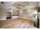 Open-concept living room with decorative fireplace and modern ceiling fan at 1409 Spyglass Hill Dr, Johns Creek, GA 30097