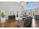 Cozy living room with a fireplace and views of the landscaped yard from bright windows at 1409 Spyglass Hill Dr, Johns Creek, GA 30097