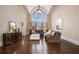 Bright living room with hardwood floors, high ceiling, and natural light from a large window at 1409 Spyglass Hill Dr, Johns Creek, GA 30097