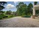 Inviting backyard pool and patio area, surrounded by lush landscaping and mature trees at 1409 Spyglass Hill Dr, Johns Creek, GA 30097