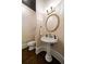 Elegant powder room featuring pedestal sink and stylish lighting fixtures at 1409 Spyglass Hill Dr, Johns Creek, GA 30097