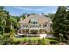 Expansive home with a pool, patio, and multi-level balconies, set amidst lush greenery at 1409 Spyglass Hill Dr, Johns Creek, GA 30097