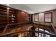 Upper landing with bookshelf and iron railing overlooking a window-lit office at 1409 Spyglass Hill Dr, Johns Creek, GA 30097