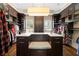 Organized walk-in closet with ample storage, hardwood floors, and custom shelving at 1409 Spyglass Hill Dr, Johns Creek, GA 30097