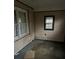 A small bedroom with paneled walls and two windows for natural light at 1643 Westhaven Sw Dr, Atlanta, GA 30311