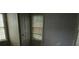 Bedroom featuring hardwood floors, wood-paneled walls, and two windows at 1643 Westhaven Sw Dr, Atlanta, GA 30311