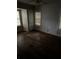 Cozy bedroom featuring hardwood floors, wood-paneled walls, and two windows at 1643 Westhaven Sw Dr, Atlanta, GA 30311