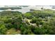 Aerial view featuring houses nestled among lush green trees with a lake in the background at 3040 Larkspur Ct, Cumming, GA 30041