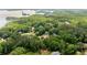 Beautiful aerial view of wooded neighborhood with lake in the background, showcasing a serene and private community setting at 3040 Larkspur Ct, Cumming, GA 30041
